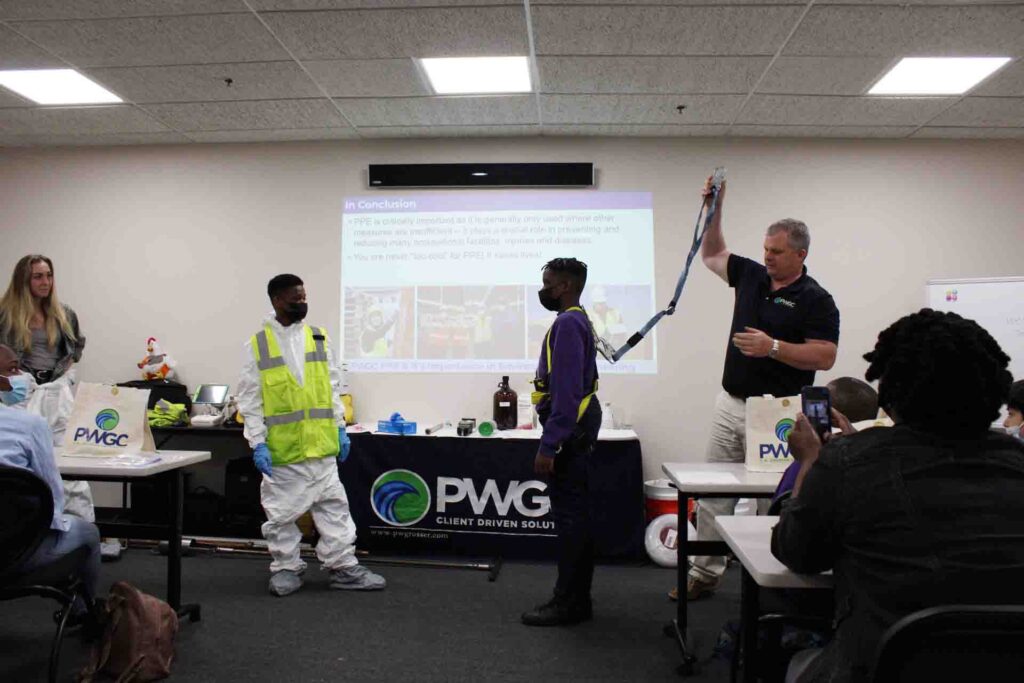 NSBE Region 1 STEM Program Visits PWGC - Kris Almskog, PG, displays safety harness on student volunteer