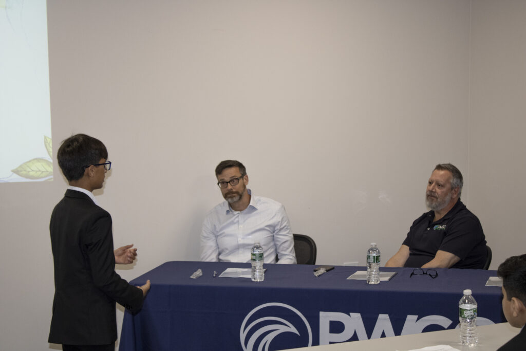 Khush Mehta speaking with Paul K. Boyce and Jim Rhodes of PWGC
